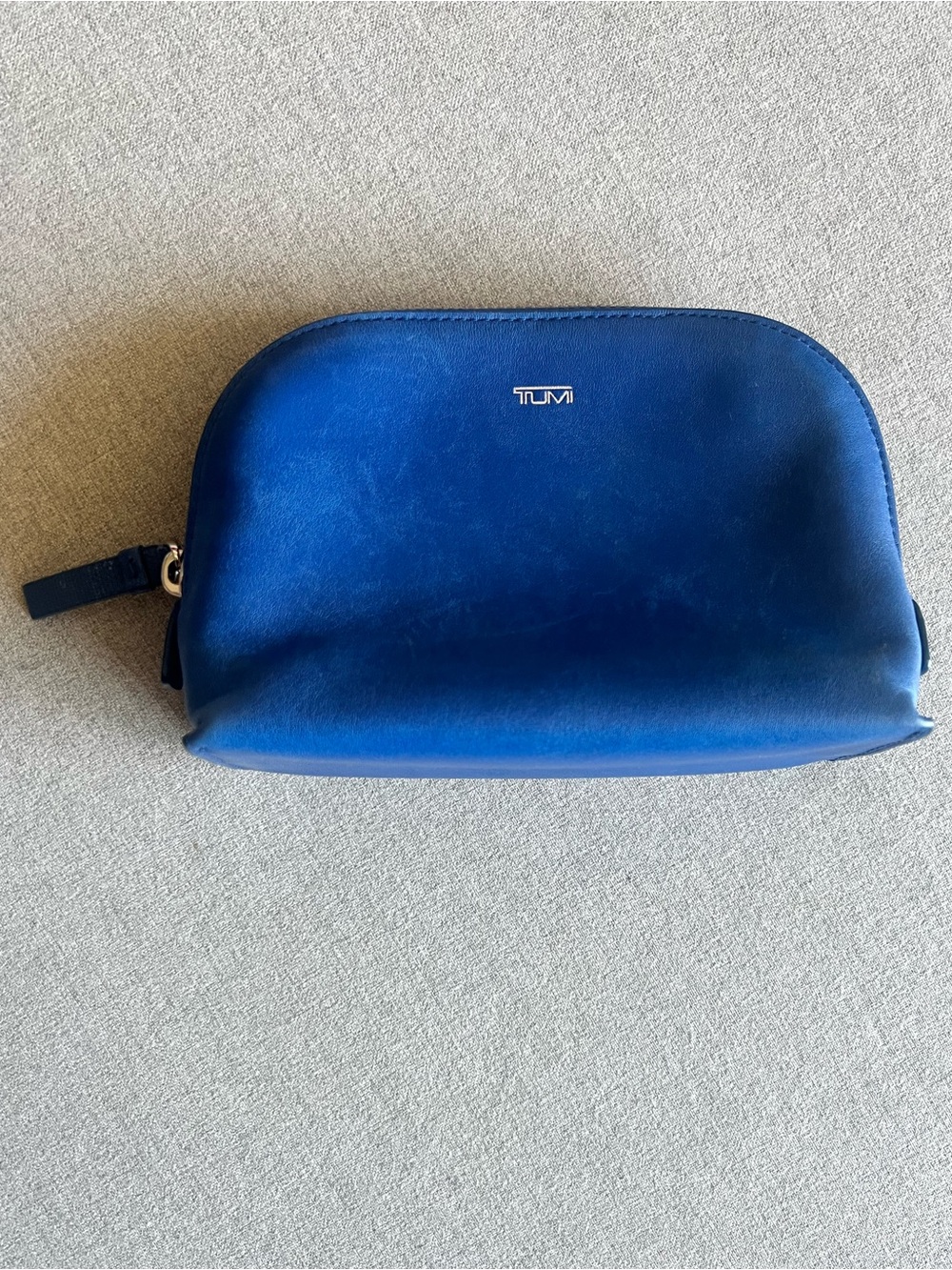 Tumi blue leather pouch with orange interior